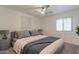 Comfortable bedroom featuring neutral decor, soft carpet, and a ceiling fan for a relaxing atmosphere at 23276 W Cocopah St, Buckeye, AZ 85326