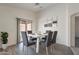 This dining room features a modern table set, art decorations, and a view to the patio at 23276 W Cocopah St, Buckeye, AZ 85326