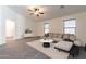 Bright, open-concept living room with modern furnishings, a fan, and neutral decor at 23276 W Cocopah St, Buckeye, AZ 85326