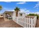 Quaint single-Gathering home with a well-kept yard, featuring a white picket fence for classic curb appeal at 241 S 54Th St, Mesa, AZ 85206