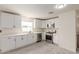 Bright kitchen features white cabinets, stainless steel appliances, and light wood-look flooring at 241 S 54Th St, Mesa, AZ 85206