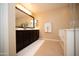 Bright bathroom featuring a double vanity, tile floors, a large mirror, and a soaking tub at 2454 E Stacey Rd, Gilbert, AZ 85298
