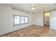 Bright bedroom featuring tiled floors, large windows, and adjacent bathroom at 2538 N 8Th St, Phoenix, AZ 85006