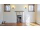 Close up of a fireplace featuring hardwood floors, two windows with wall sconces, and plenty of charm at 2538 N 8Th St, Phoenix, AZ 85006