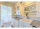 Kitchen featuring white cabinets, a farmhouse sink, ample counter space, and hardwood floors at 2538 N 8Th St, Phoenix, AZ 85006