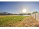 Expansive backyard with grass, concrete slab, pool, and open space at 25903 S Lemon Ave, Queen Creek, AZ 85142