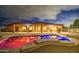 Stunning backyard pool with colorful lighting, creating a magical and inviting atmosphere for nighttime swims at 25903 S Lemon Ave, Queen Creek, AZ 85142