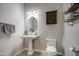 Bathroom featuring a pedestal sink, an oval mirror, and gray hand towels at 25903 S Lemon Ave, Queen Creek, AZ 85142