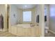 Bright bathroom featuring a soaking tub, window, and elegant finishes for a relaxing space at 25903 S Lemon Ave, Queen Creek, AZ 85142