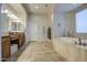 Luxurious bathroom featuring double vanities, and a relaxing soaking tub at 25903 S Lemon Ave, Queen Creek, AZ 85142