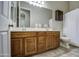 Bathroom featuring a double vanity sink, dark wood cabinetry, and a tile floor at 25903 S Lemon Ave, Queen Creek, AZ 85142