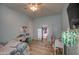 Bright bedroom featuring tiled floors, a ceiling fan, and an adjacent walk-in closet at 25903 S Lemon Ave, Queen Creek, AZ 85142