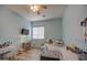 Comfortable bedroom with blue walls, a ceiling fan, and a mounted television at 25903 S Lemon Ave, Queen Creek, AZ 85142