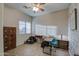 A bedroom-turned-office featuring neutral walls, a desk, and tiled flooring at 25903 S Lemon Ave, Queen Creek, AZ 85142