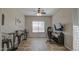 Bedroom featuring a ceiling fan, a window, a mounted TV, and a gaming chair at 25903 S Lemon Ave, Queen Creek, AZ 85142