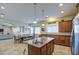 Open kitchen with center island and breakfast bar overlooking the dining and living areas at 25903 S Lemon Ave, Queen Creek, AZ 85142