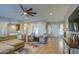 Open-concept living room featuring a plush sofa, two armchairs, and neutral tones at 25903 S Lemon Ave, Queen Creek, AZ 85142