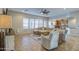 Open-concept living room with lots of natural light, a comfortable sofa, and a view into the kitchen at 25903 S Lemon Ave, Queen Creek, AZ 85142