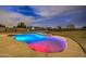 Night view of in-ground pool with colorful lighting and waterfall at 25903 S Lemon Ave, Queen Creek, AZ 85142