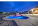 Sparkling pool at dusk with covered patio and mountain views at 25903 S Lemon Ave, Queen Creek, AZ 85142