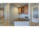 Stylish wet bar with granite countertop, wine rack, and glass storage, perfect for entertaining at 25903 S Lemon Ave, Queen Creek, AZ 85142