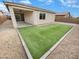 A backyard featuring a covered patio and a neatly maintained patch of artificial grass at 25912 N Langley Dr, Peoria, AZ 85383