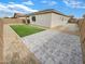 Paver patio in a backyard and artificial grass that offers low maintenance and a clean look at 25912 N Langley Dr, Peoria, AZ 85383