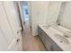 Bathroom featuring double sinks with a gray vanity, light countertops and modern fixtures and wood-look flooring at 25912 N Langley Dr, Peoria, AZ 85383