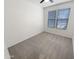 This bedroom features neutral carpet, a ceiling fan, and bright natural light from the window at 25912 N Langley Dr, Peoria, AZ 85383