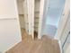 Bathroom hallway with a linen closet featuring built-in shelving for organized storage at 25912 N Langley Dr, Peoria, AZ 85383