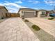 Single-story home with a spacious driveway, two-car garage, and low-maintenance landscaping at 25912 N Langley Dr, Peoria, AZ 85383