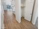 Hallway leading to a kitchen featuring wood floors, a closet, and neutral decor at 25912 N Langley Dr, Peoria, AZ 85383