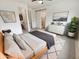 Well-lit main bedroom featuring a wooden bed frame, walk in closet, and ensuite bathroom at 25912 N Langley Dr, Peoria, AZ 85383