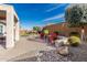 Beautiful backyard with pavers, rock landscaping, desert plants, and comfortable patio seating at 25983 W Escuda Dr, Buckeye, AZ 85396