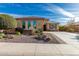 Tan single-Gathering home with desert landscaping out front, decorative rock, desert plants, and a small tree at 25983 W Escuda Dr, Buckeye, AZ 85396