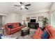 Comfortable living room with ceiling fan, fireplace, sofas, rug, and natural light, perfect for relaxing and entertaining at 25983 W Escuda Dr, Buckeye, AZ 85396