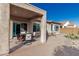 Covered patio with stone flooring and dining set, perfect for outdoor entertaining and relaxation at 25983 W Escuda Dr, Buckeye, AZ 85396