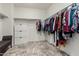 Bright walk-in closet with shelves and hanging rods providing ample storage space at 25983 W Escuda Dr, Buckeye, AZ 85396