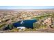 Aerial view of a community and golf course featuring a pond with a fountain at 27138 W Escuda Dr, Buckeye, AZ 85396