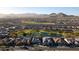 Scenic aerial view of a golf course community with homes, a pond and desert mountains in the background at 27138 W Escuda Dr, Buckeye, AZ 85396