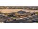 A high angle shows a shopping center at an intersection with landscaping and desert in the background at 27138 W Escuda Dr, Buckeye, AZ 85396