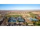 Spacious aerial view of a golf course community, showing tennis courts and a refreshing swimming pool at 27138 W Escuda Dr, Buckeye, AZ 85396