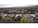 Aerial view of houses with solar panels and mountain views in the distance at 27138 W Escuda Dr, Buckeye, AZ 85396