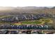 Wide aerial shot of a community near a golf course showcasing beautiful homes, lush greens and a serene environment at 27138 W Escuda Dr, Buckeye, AZ 85396