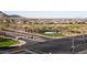 The community entrance is shown in an aerial view with landscaping and views of the community at 27138 W Escuda Dr, Buckeye, AZ 85396