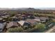 Aerial view of houses with solar panels near a golf course and mountains at 27138 W Escuda Dr, Buckeye, AZ 85396