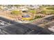 Aerial view of a well-manicured traffic circle featuring mature landscaping and neighborhood entry monument at 27138 W Escuda Dr, Buckeye, AZ 85396