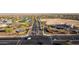 Aerial view of a community with a well-planned entrance, lush landscaping, retail and road network at 27138 W Escuda Dr, Buckeye, AZ 85396