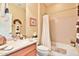 Bright bathroom with a vanity, mirror, toilet and tub with shower curtain at 27138 W Escuda Dr, Buckeye, AZ 85396