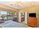 Well-lit bedroom features a large window, neutral walls, and en-suite bathroom access, enhancing comfort and convenience at 27138 W Escuda Dr, Buckeye, AZ 85396